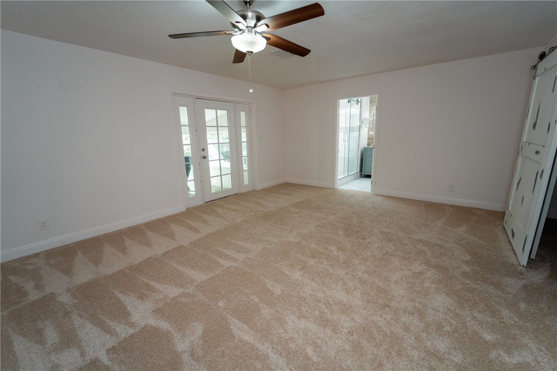 1985 Laguna Road Mohave Valley, AZ 86440 - Photo 24 of 83 Spacious room featuring carpeting, a ceiling fan, and white French doors