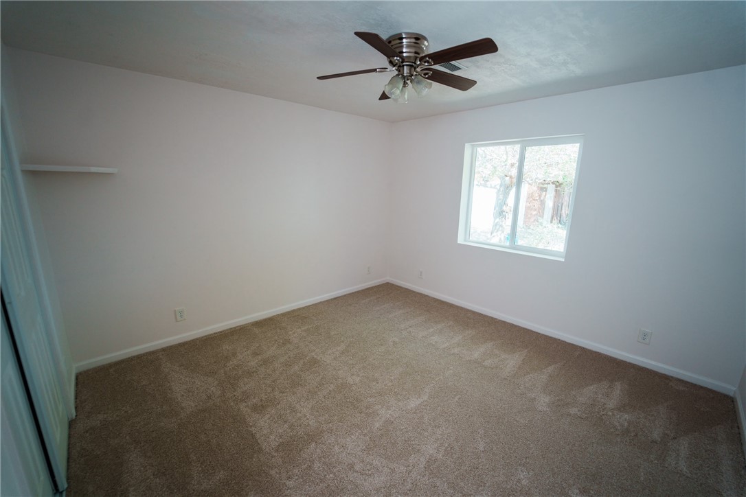 1985 Laguna Road Mohave Valley, AZ 86440 - Photo 45 of 83 This room features neutral-toned carpeting, white walls, and a window providing natural light