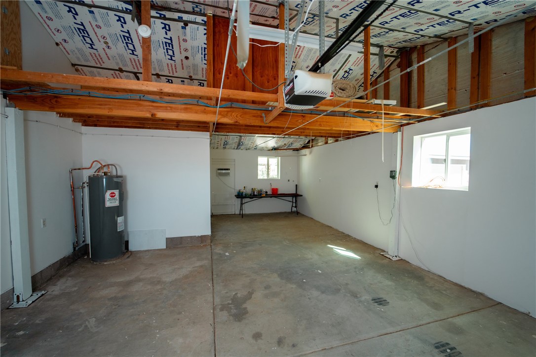 1985 Laguna Road Mohave Valley, AZ 86440 - Photo 48 of 83 The property features a spacious garage with a concrete floor, exposed wooden beams, and white walls