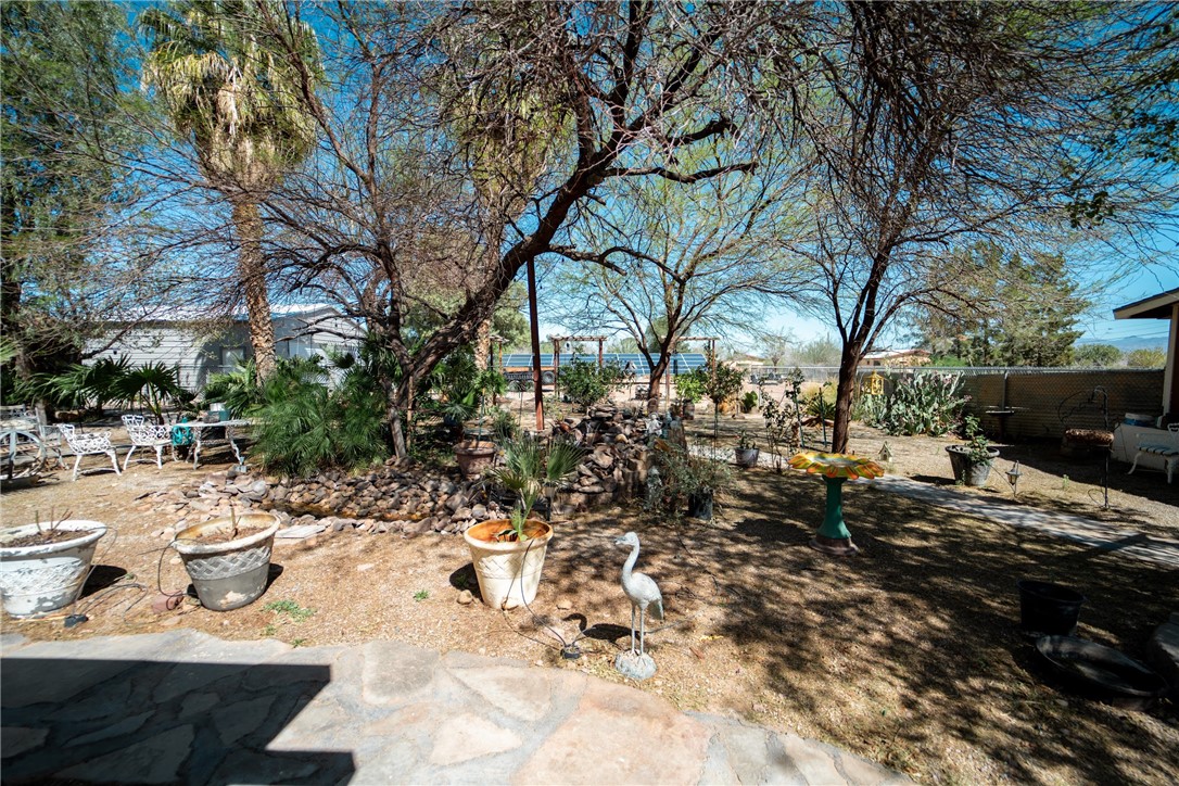 1985 Laguna Road Mohave Valley, AZ 86440 - Photo 53 of 83 The property features a spacious yard with mature trees and a partial stone patio