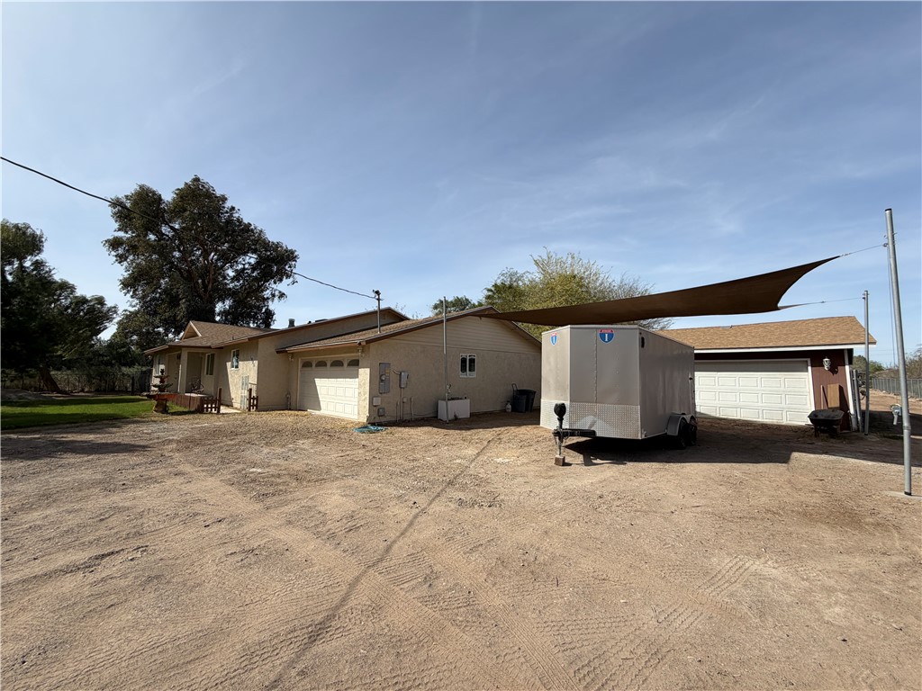 1985 Laguna Road Mohave Valley, AZ 86440 - Photo 6 of 83 View of side of home with driveway, shaded parking and garage.