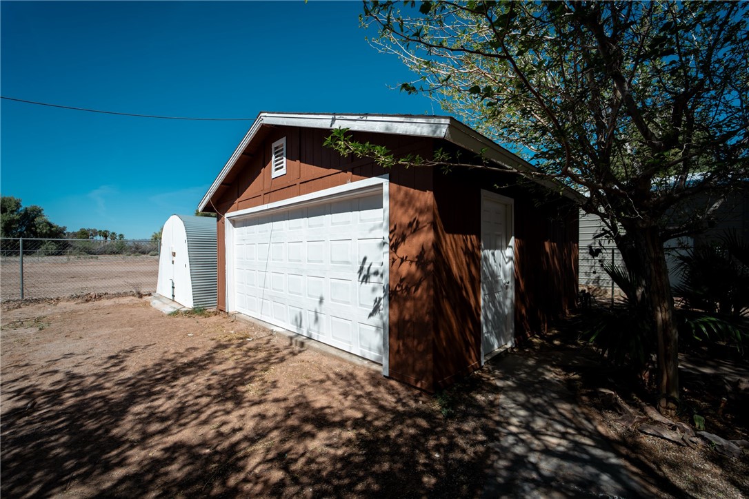1985 Laguna Road Mohave Valley, AZ 86440 - Photo 66 of 83 The property features a detached garage with a white panel door and a side entry door