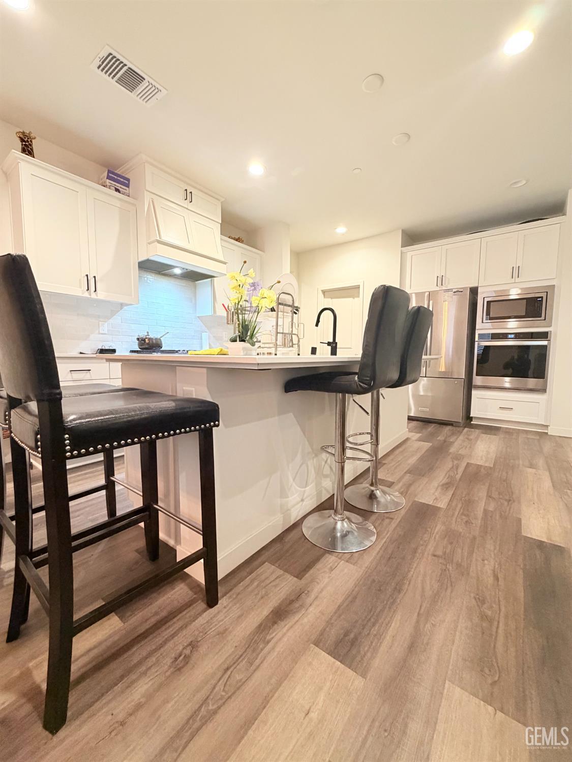 Undisclosed Address Bakersfield, CA 93313 - Photo 11 of 24 a living room with stainless steel appliances kitchen island granite countertop furniture and wooden floor