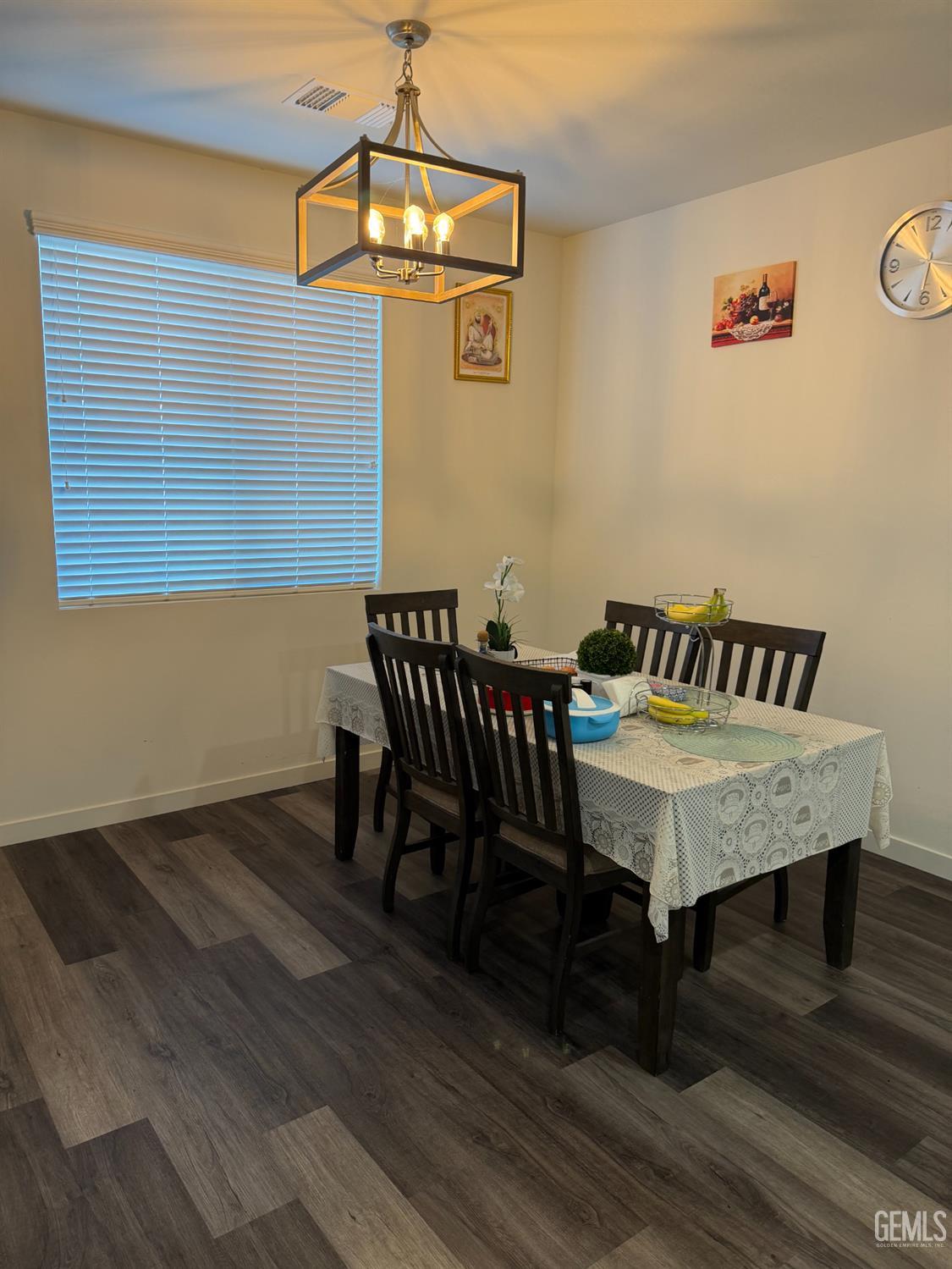 Undisclosed Address Bakersfield, CA 93313 - Photo 12 of 24 a dining room with furniture and wooden floor