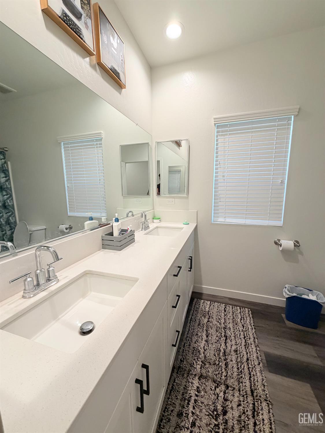 Undisclosed Address Bakersfield, CA 93313 - Photo 16 of 24 a bathroom with a double vanity sink a mirror and a