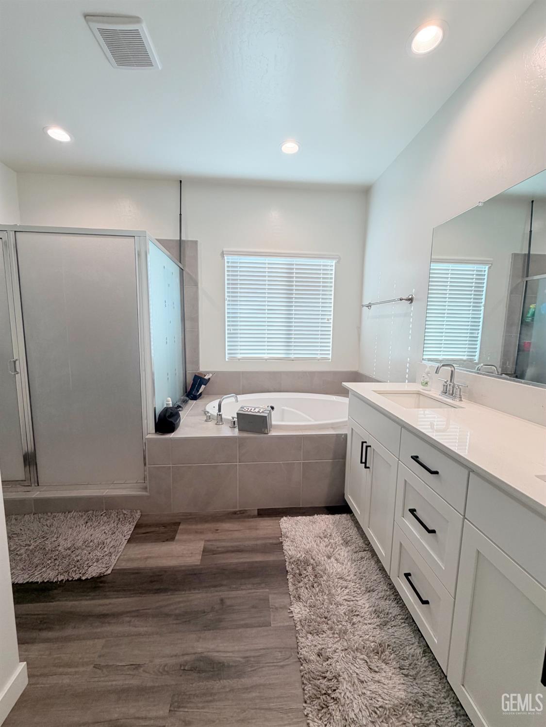 Undisclosed Address Bakersfield, CA 93313 - Photo 5 of 24 a bathroom with a tub sink and mirror