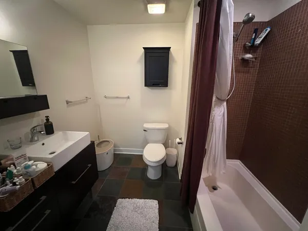 a bathroom with a toilet sink and mirror