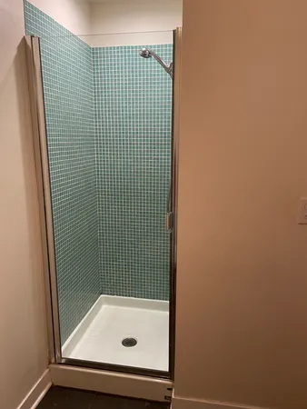 a bathroom with a tub and shower