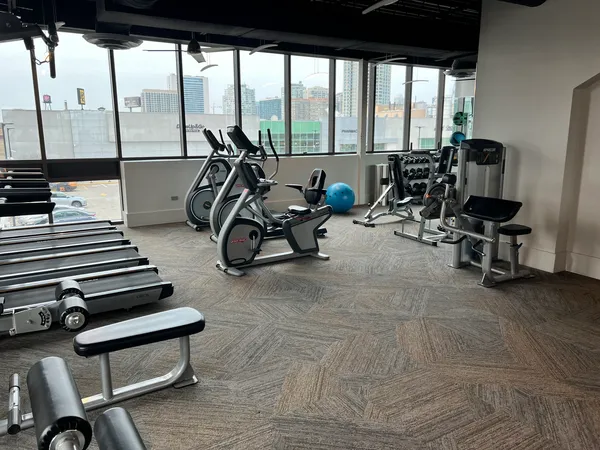 a view of a room with gym equipment and floor to ceiling window