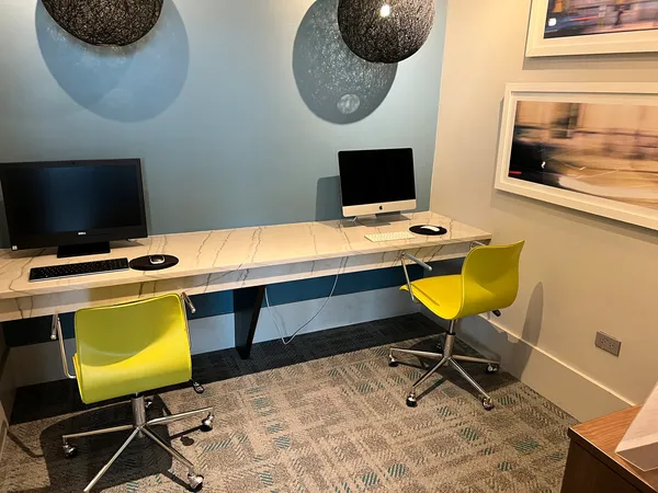 a room with table chairs and a flat screen tv