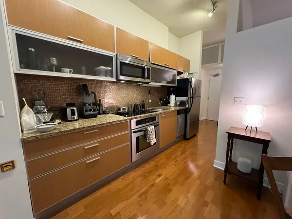 a kitchen with stainless steel appliances a stove and a refrigerator