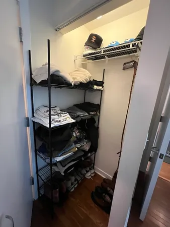 a view of a hallway with furniture and a window