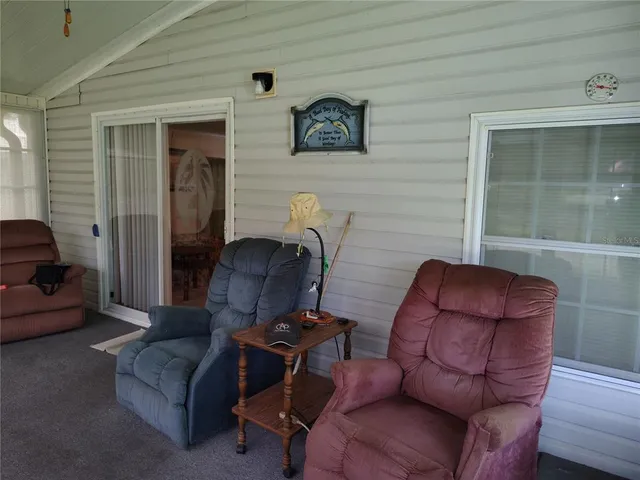 a living room with furniture a wooden floor and a chandelier