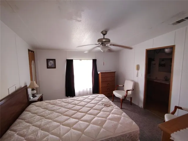 a view of a workspace with furniture and wooden floor