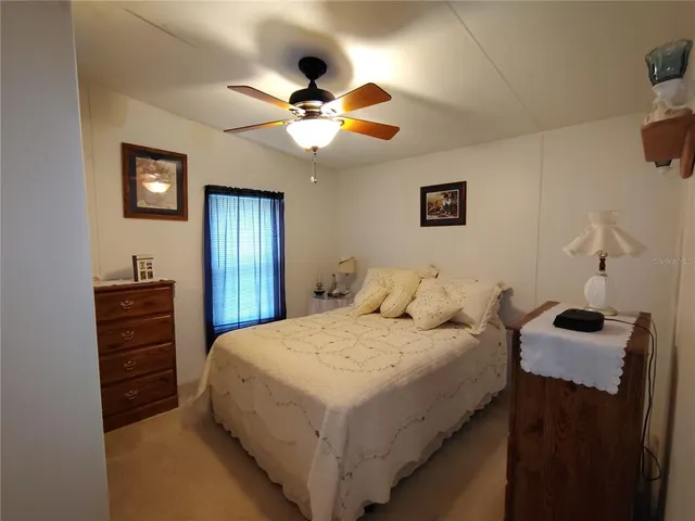 a kitchen with a table chairs refrigerator and microwave