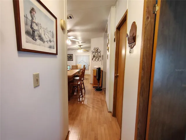 a living room with furniture flowerpot and a window
