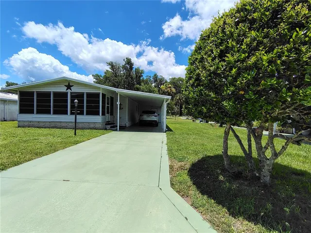 a living room with furniture fireplace and a large window