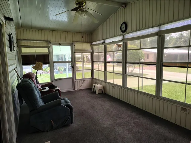 a dining room with furniture a chandelier and wooden floor