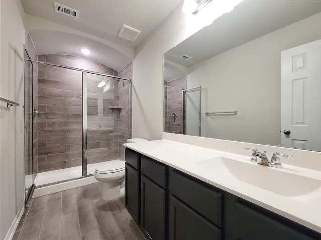 a bathroom with a double vanity sink and mirror