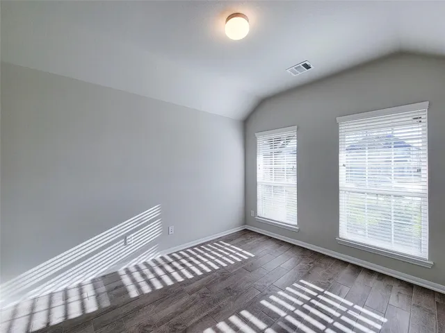 a view of wooden floor and windows in a room