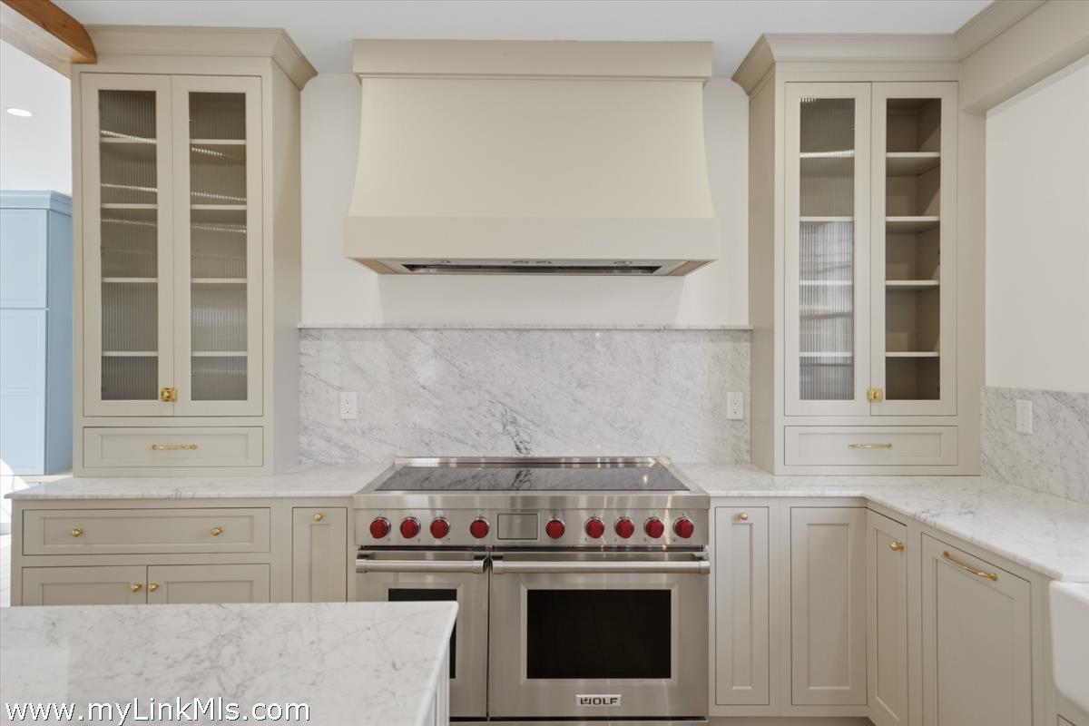 85 Orange Street Nantucket, MA 02554 - Photo 17 of 89 a kitchen with a stove and a cabinet