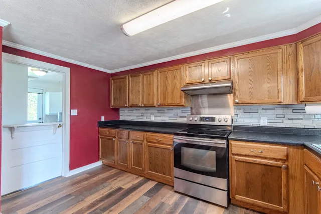 a kitchen with stainless steel appliances granite countertop a stove and a sink