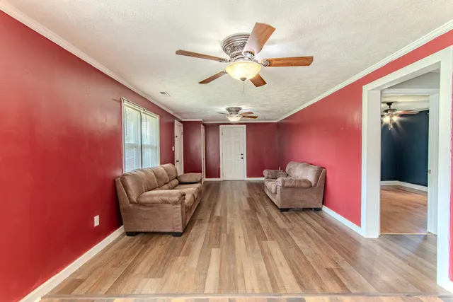 a living room with furniture and a chandelier