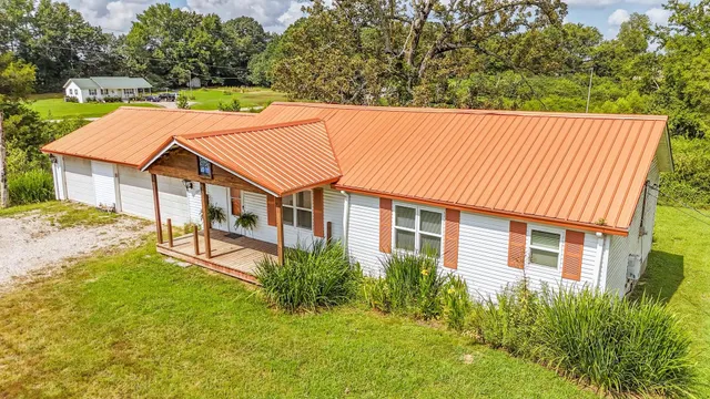 a aerial view of a house with a yard