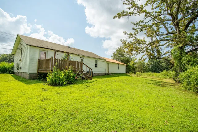 a front view of house with yard and trees