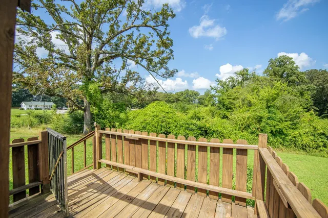 a view of a balcony with wooden floor