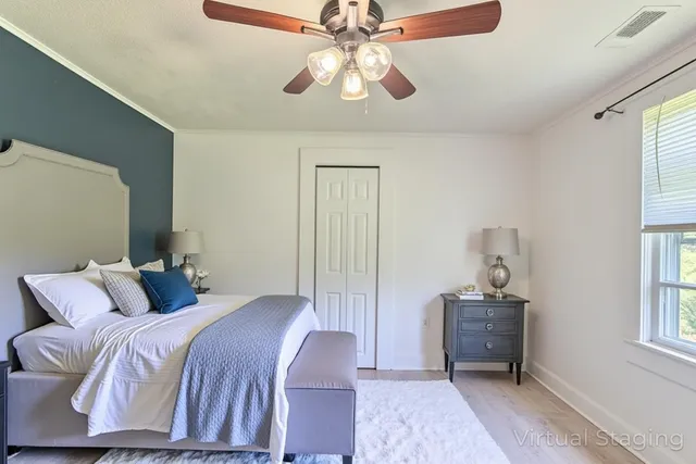 a bedroom with a bed and a chandelier