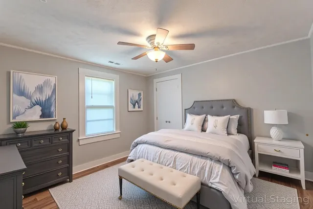 a bedroom with a bed and wooden floor
