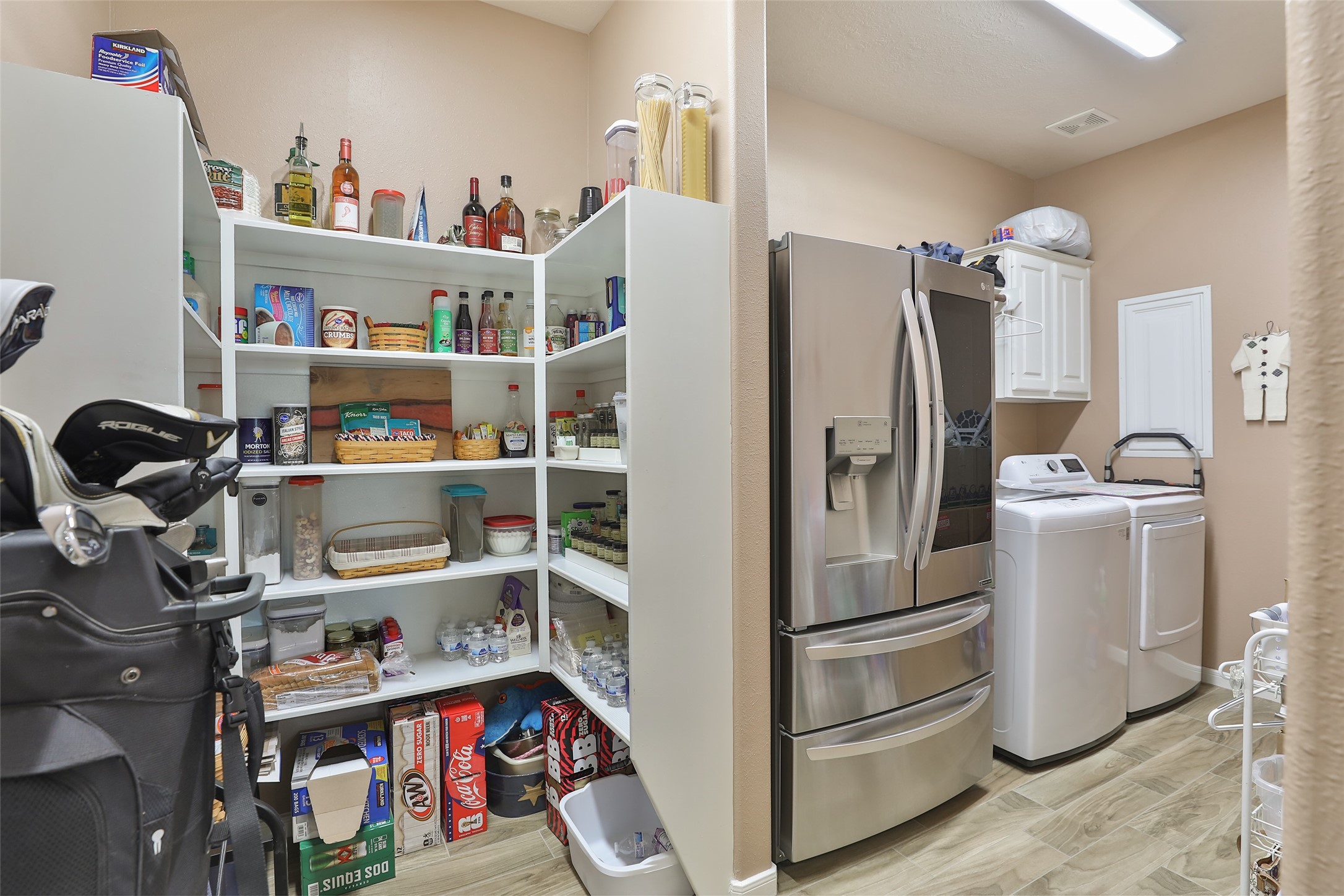 20519 Windrose Bend Drive Spring, TX 77379 - Photo 15 of 37 This thoughtfully designed walk-in pantry offers direct access to large laundry room, providing ample storage space for organizing household essentials and maintaining a clutter-free kitchen.