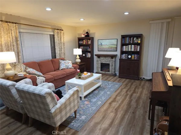 a living room with furniture fireplace and a flat screen tv