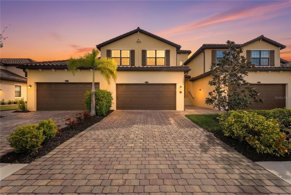 12490 Ghiberti Circle, Unit 201 Venice, FL 34293 - Photo 1 of 1 a front view of a house with a yard and garage