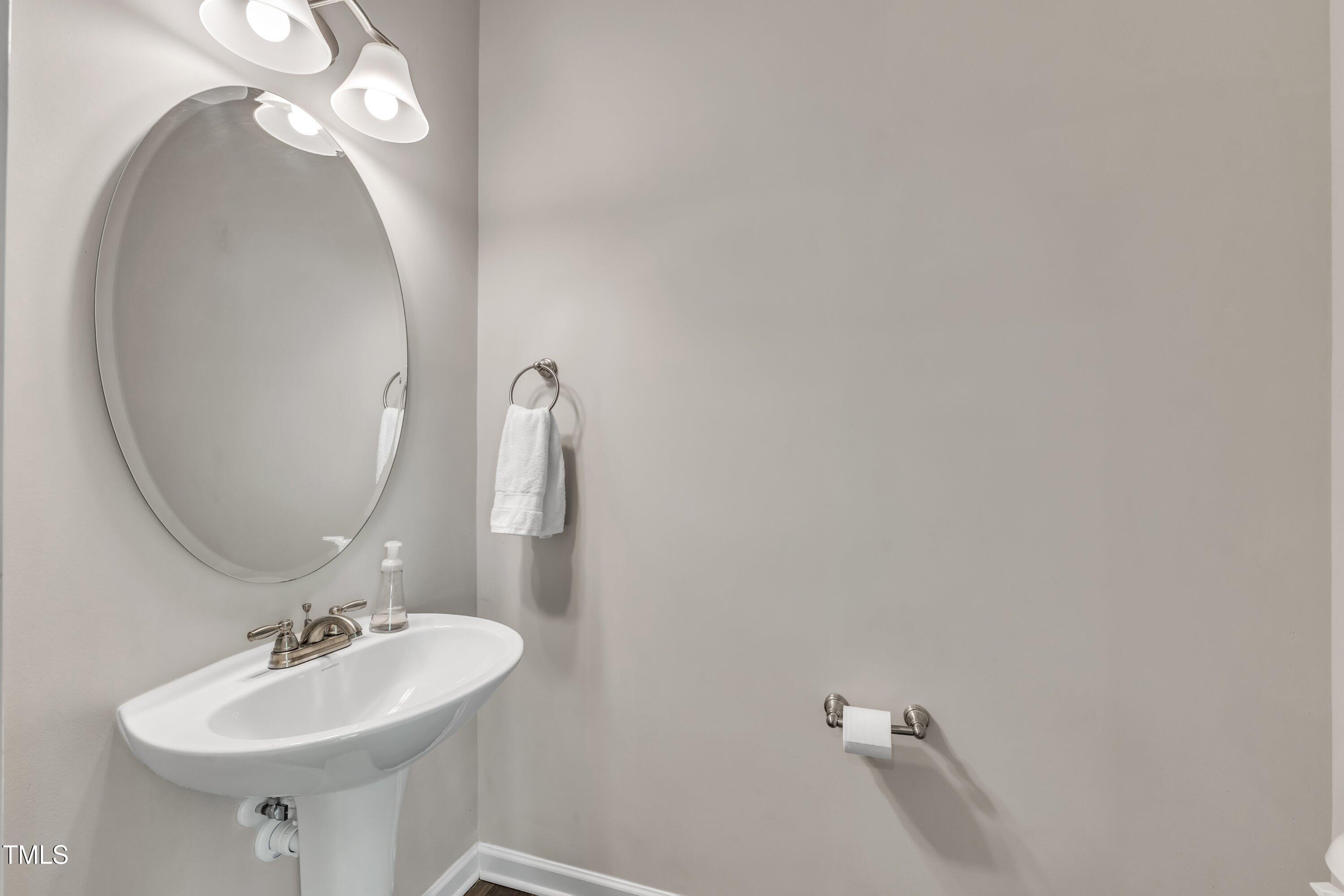 1230 Wingstem Place Raleigh, NC 27607 - Photo 17 of 41 a bathroom with a sink and a mirror