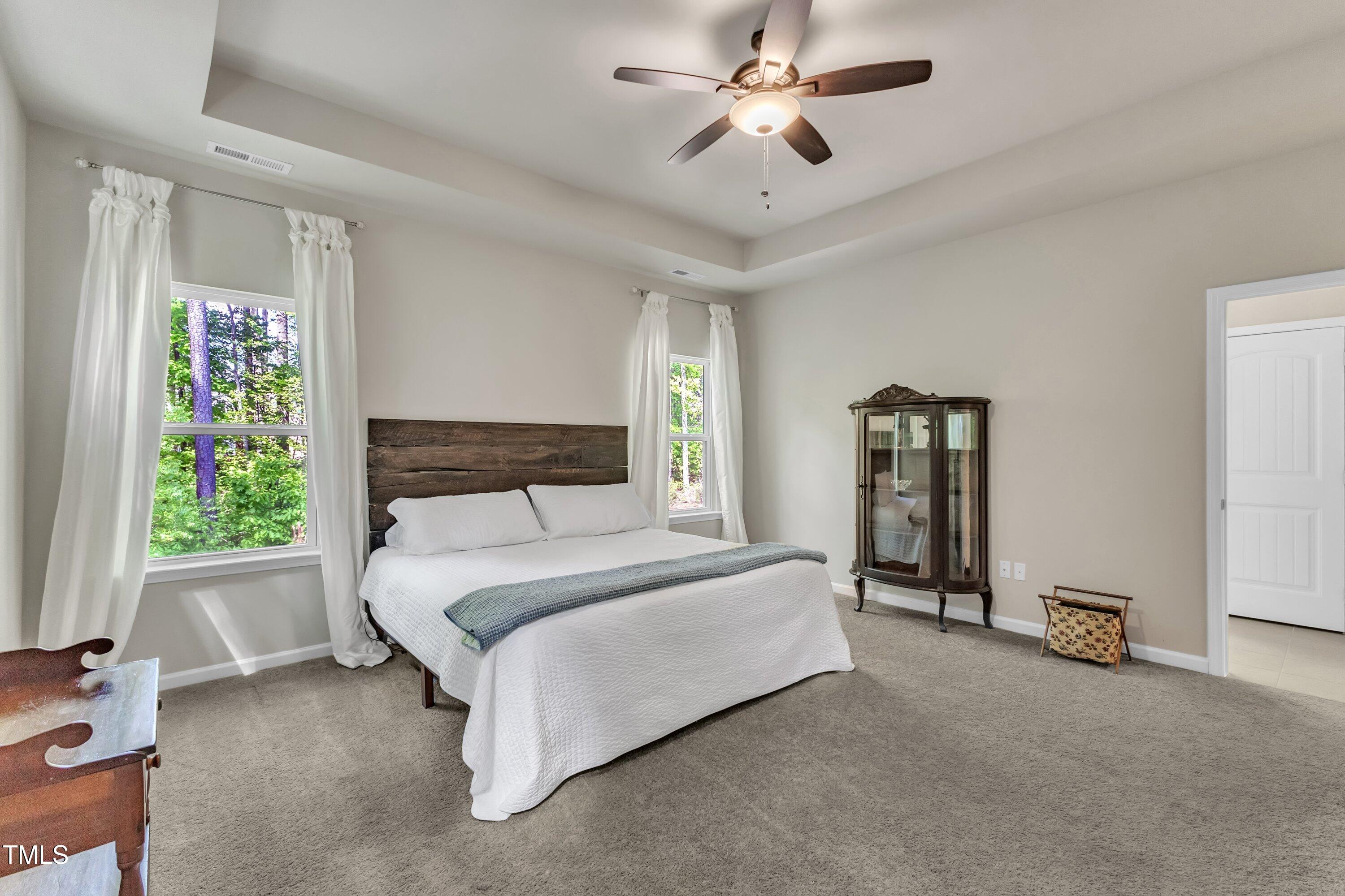 1230 Wingstem Place Raleigh, NC 27607 - Photo 21 of 41 a spacious bedroom with a bed and a window