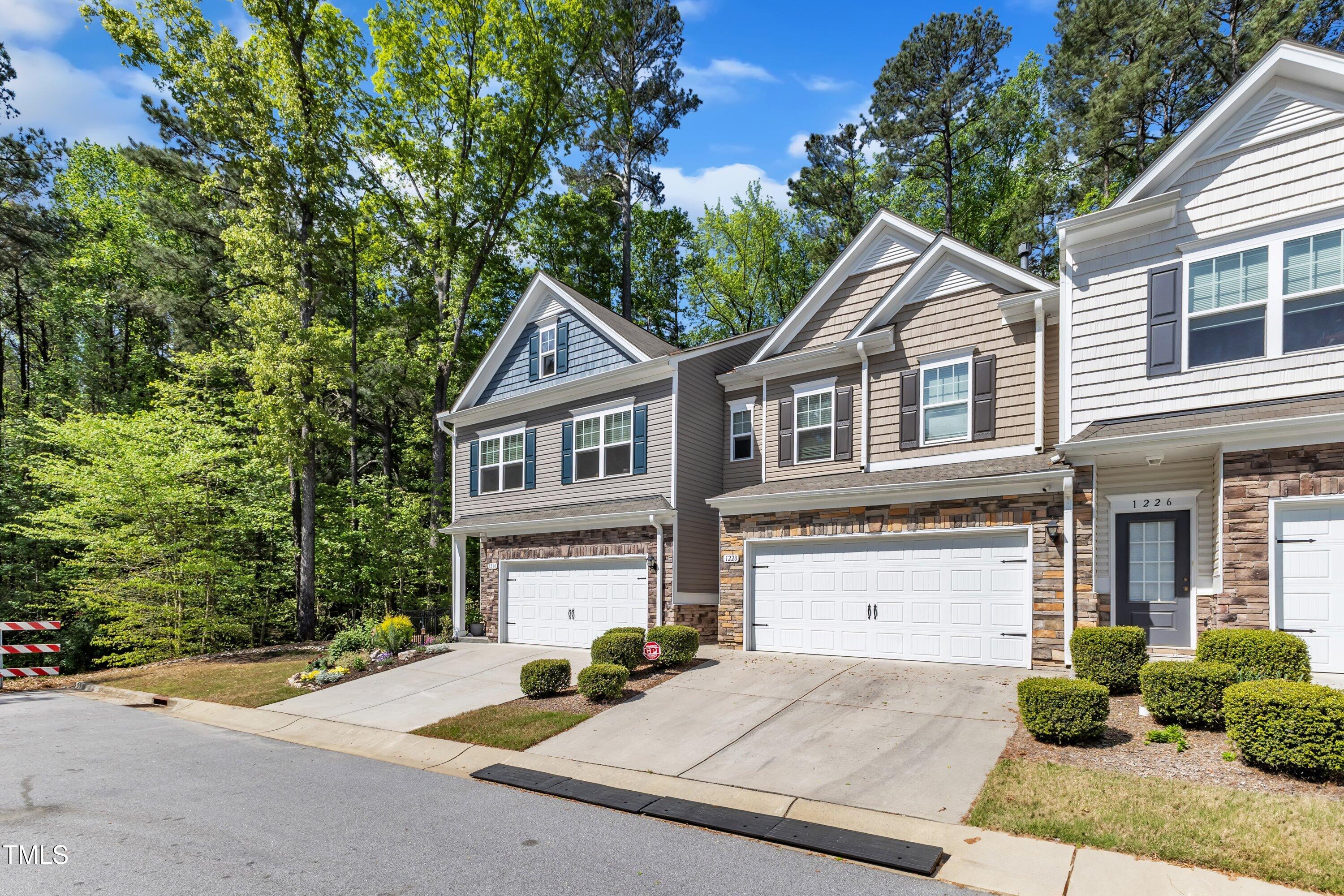 1230 Wingstem Place Raleigh, NC 27607 - Photo 2 of 41 a front view of a house with yard and parking