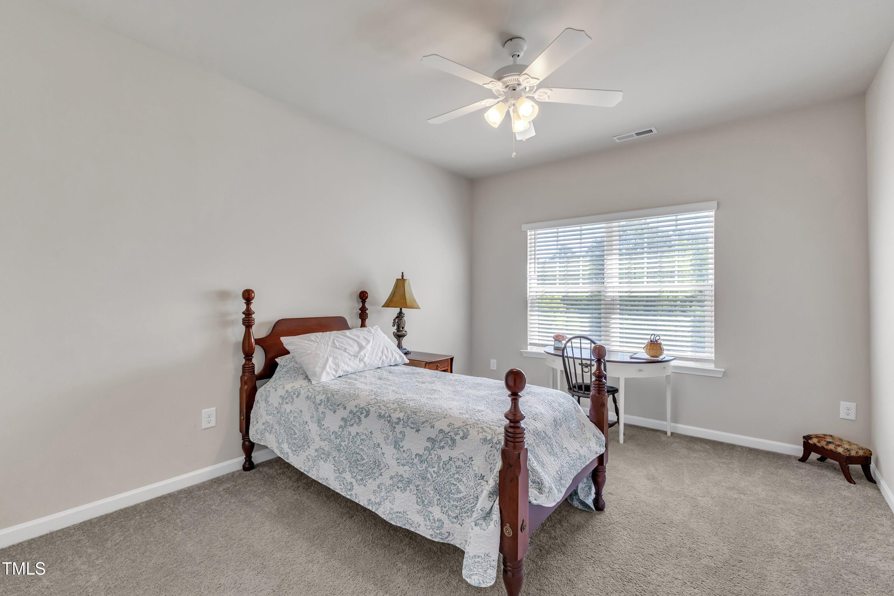 1230 Wingstem Place Raleigh, NC 27607 - Photo 30 of 41 a bed room with a bed and a chair