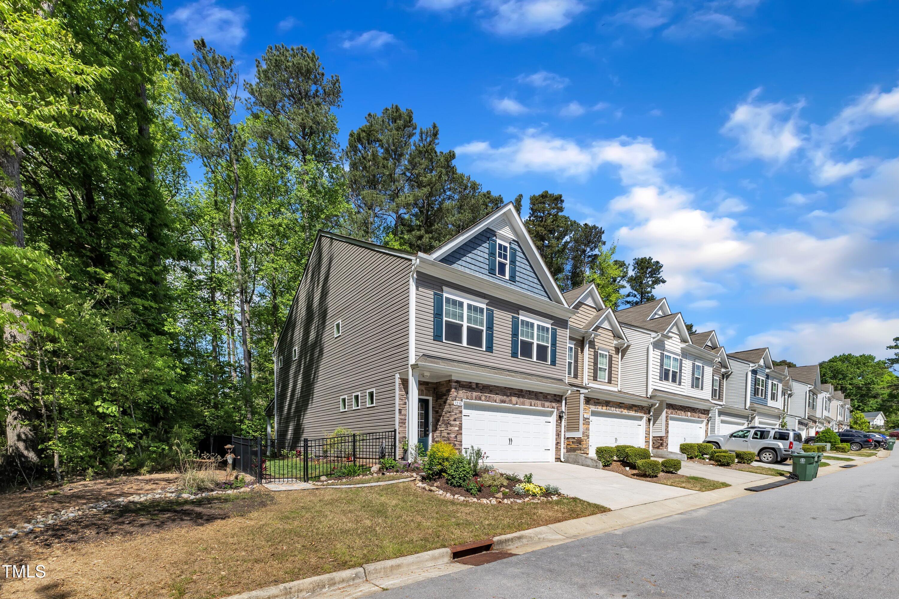 1230 Wingstem Place Raleigh, NC 27607 - Photo 3 of 41 a front view of a house with a garden