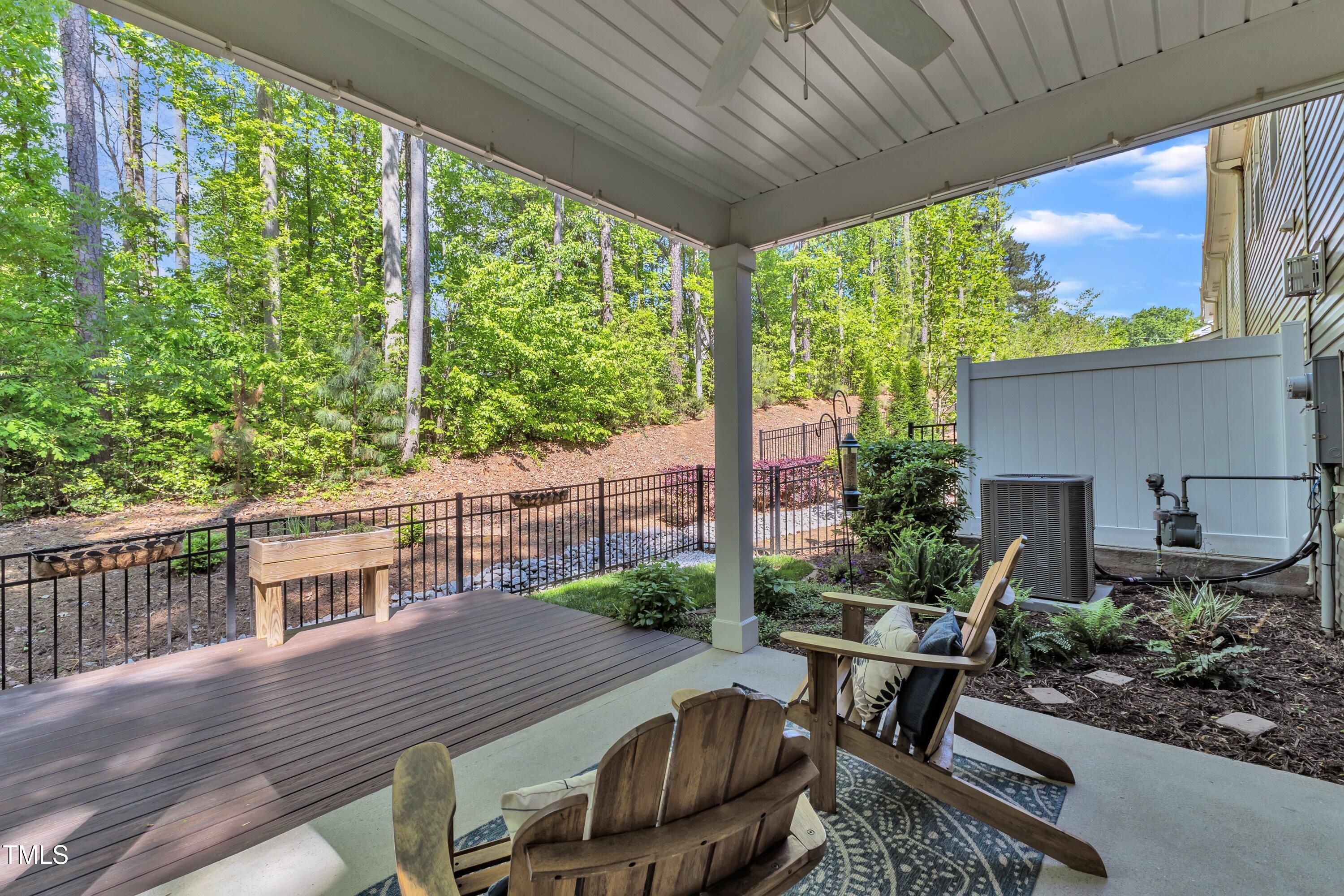 1230 Wingstem Place Raleigh, NC 27607 - Photo 40 of 41 a view of a patio with table and chairs potted plants with wooden floor and fence