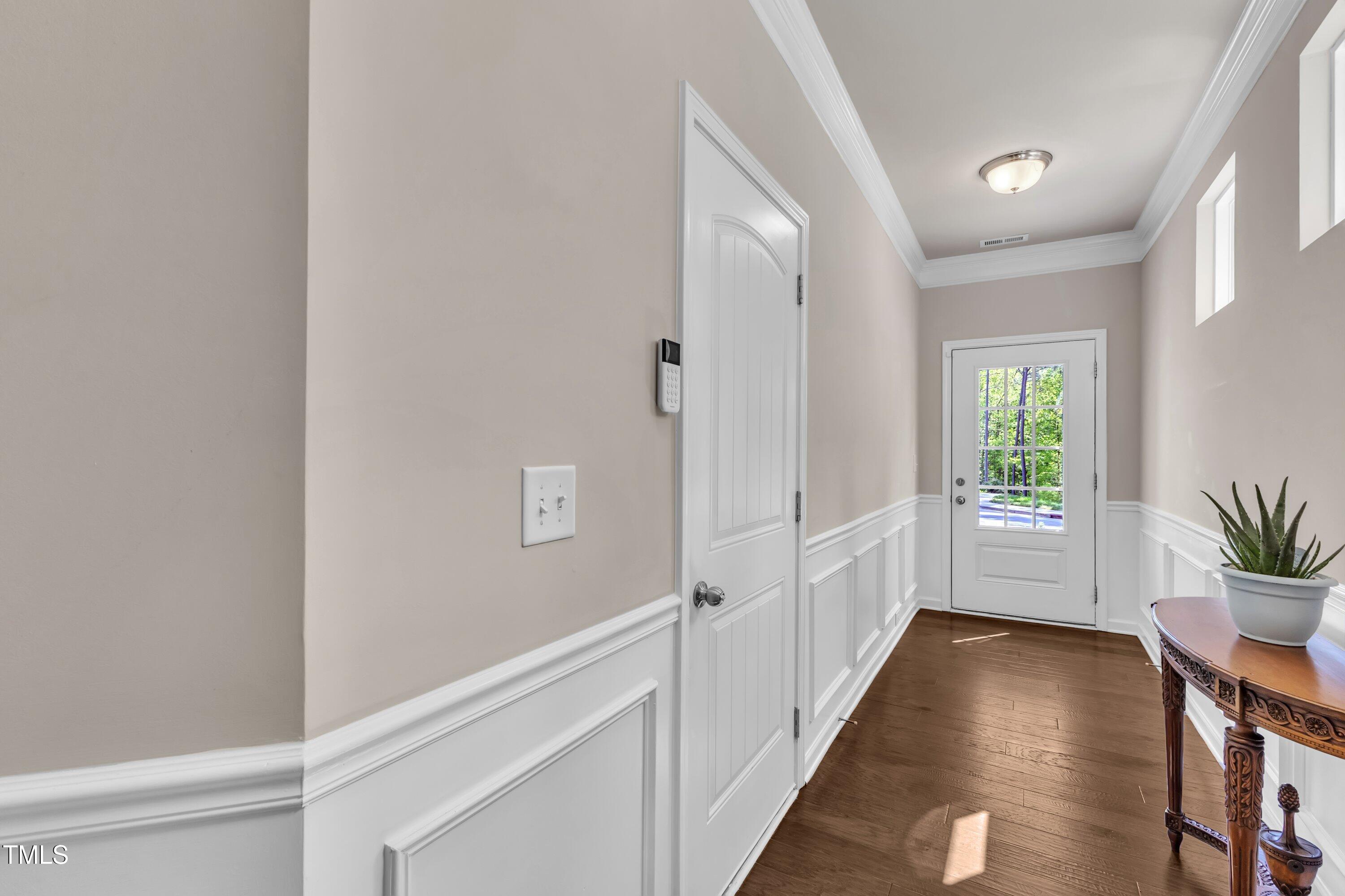 1230 Wingstem Place Raleigh, NC 27607 - Photo 7 of 41 a view of hallway with window and wooden floor
