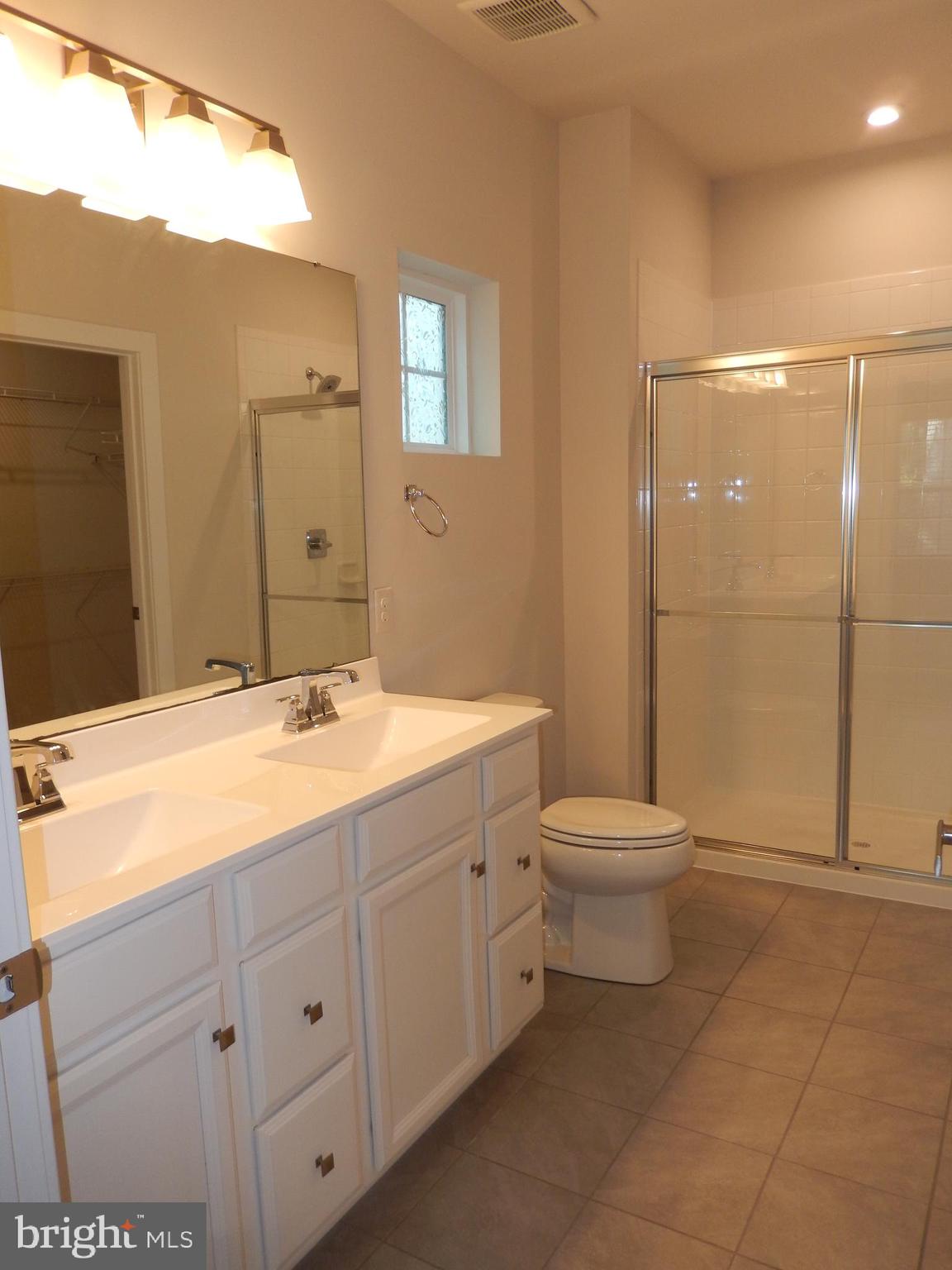 36884 Red Cedar Loop Ocean View, DE 19970 - Photo 28 of 50 a bathroom with a toilet a sink a mirror and a shower