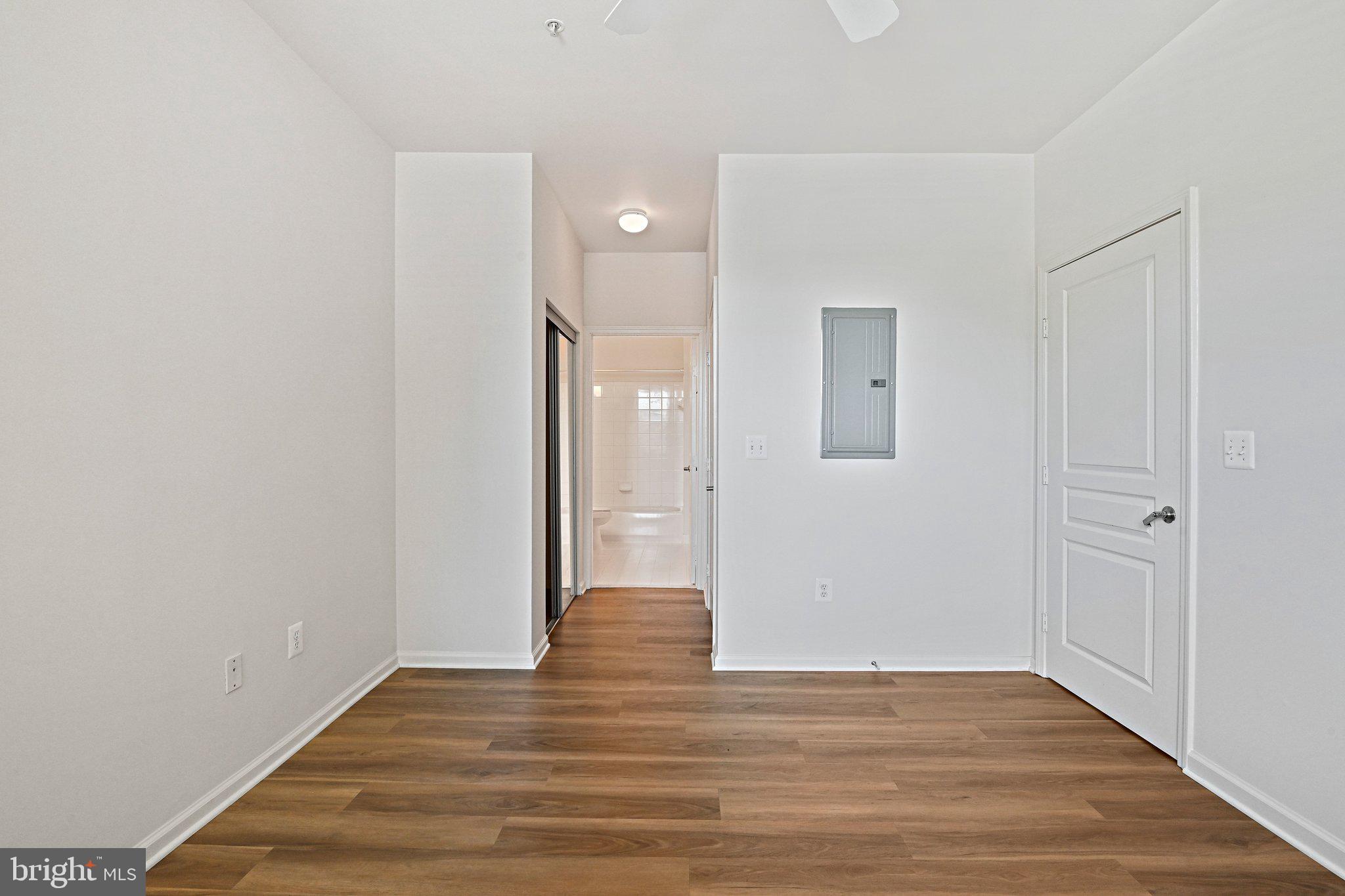 12001 Market Street, Unit 151 Reston, VA 20190 - Photo 12 of 25 a view of a hallway with wooden floor