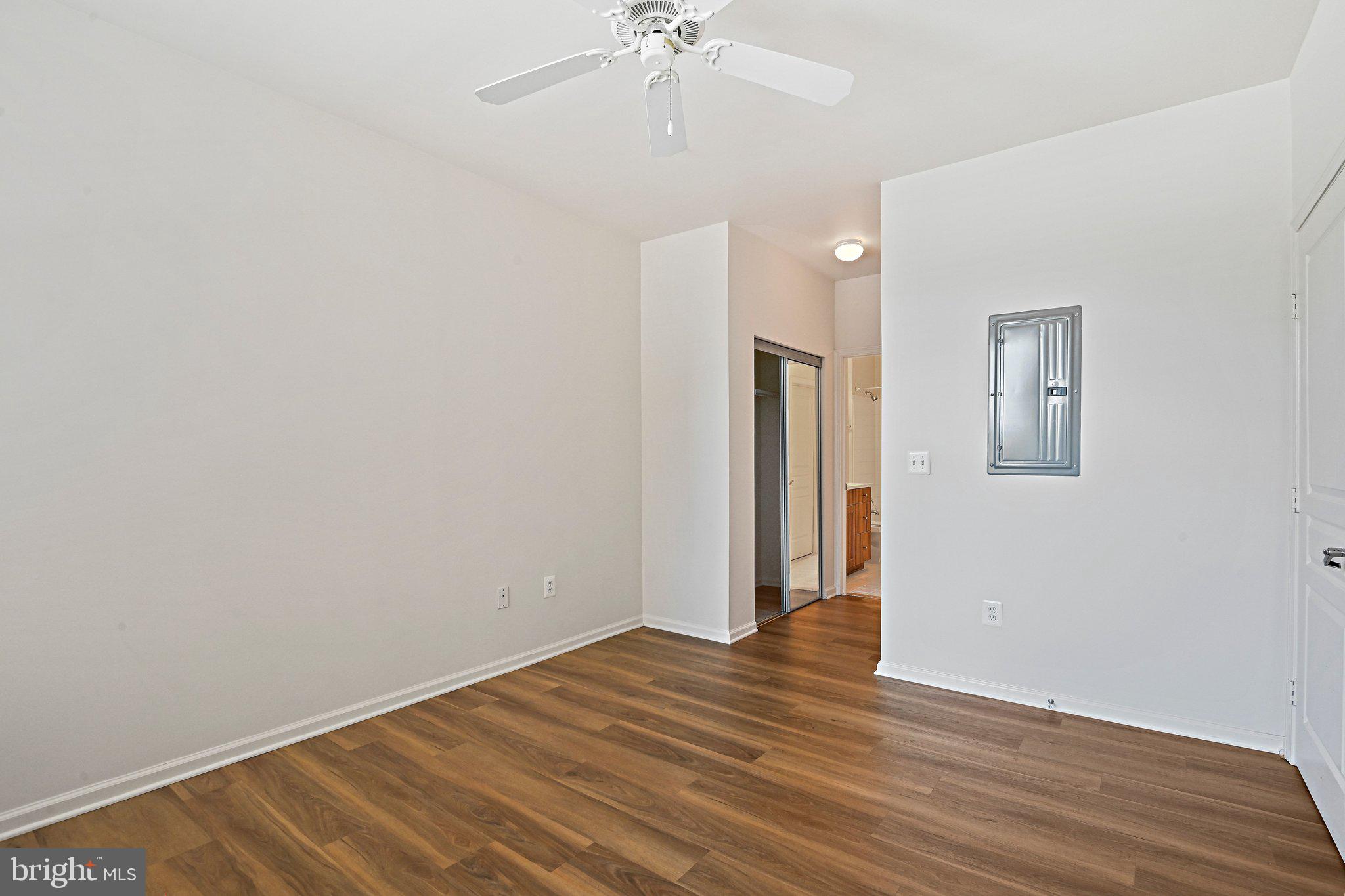 12001 Market Street, Unit 151 Reston, VA 20190 - Photo 13 of 25 a view of an empty room with wooden floor