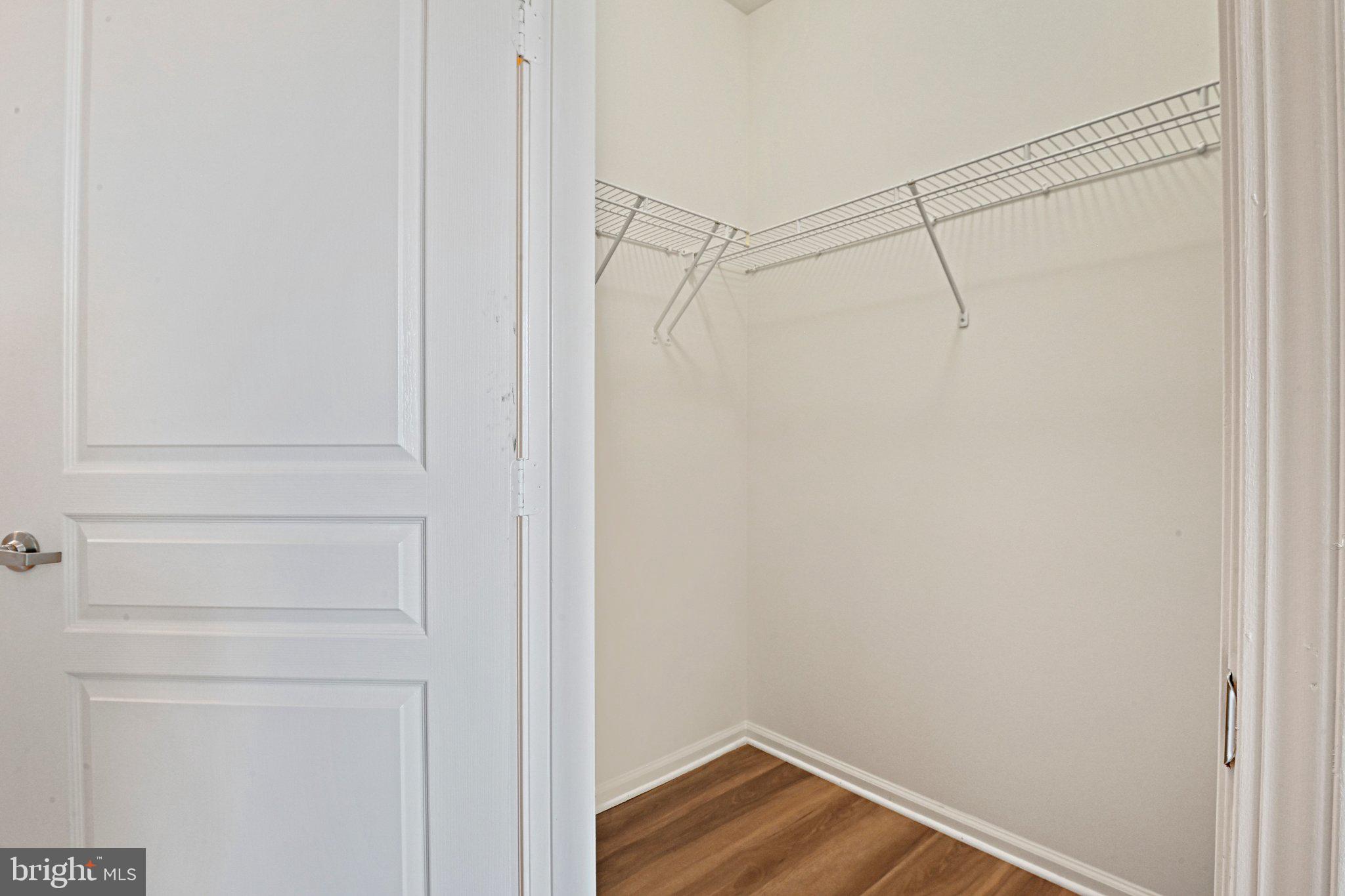 12001 Market Street, Unit 151 Reston, VA 20190 - Photo 14 of 25 a view of a room with wooden floor