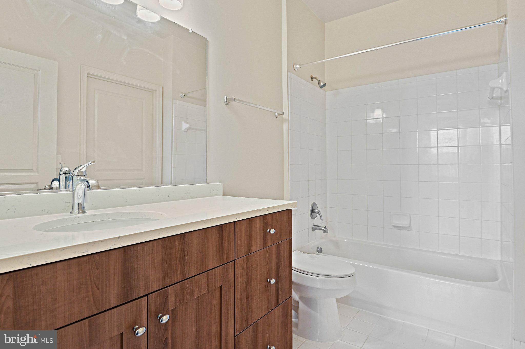 12001 Market Street, Unit 151 Reston, VA 20190 - Photo 16 of 25 a bathroom with a sink a toilet and shower