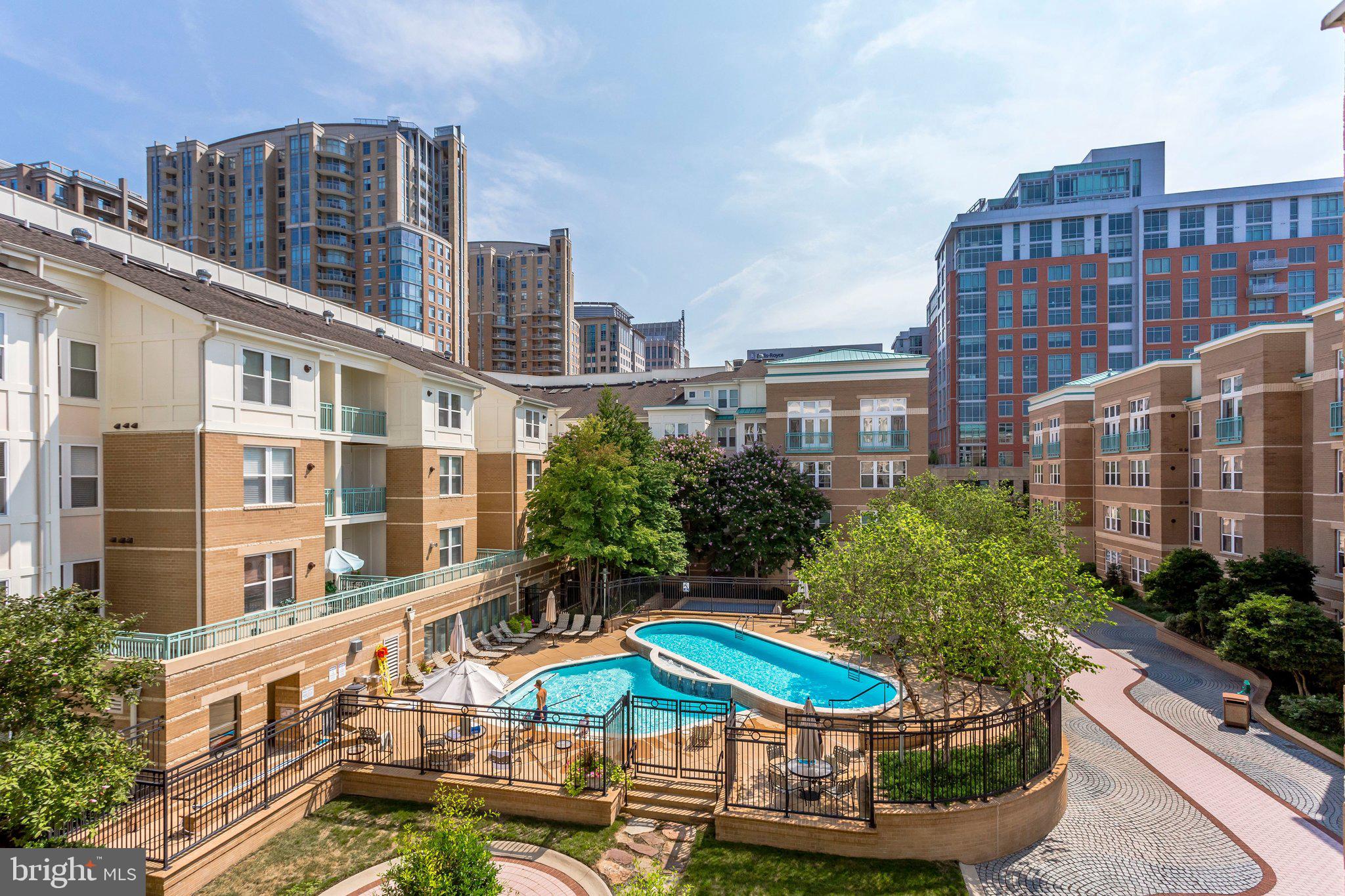 12001 Market Street, Unit 151 Reston, VA 20190 - Photo 18 of 25 a view of a building with garden space and sitting area