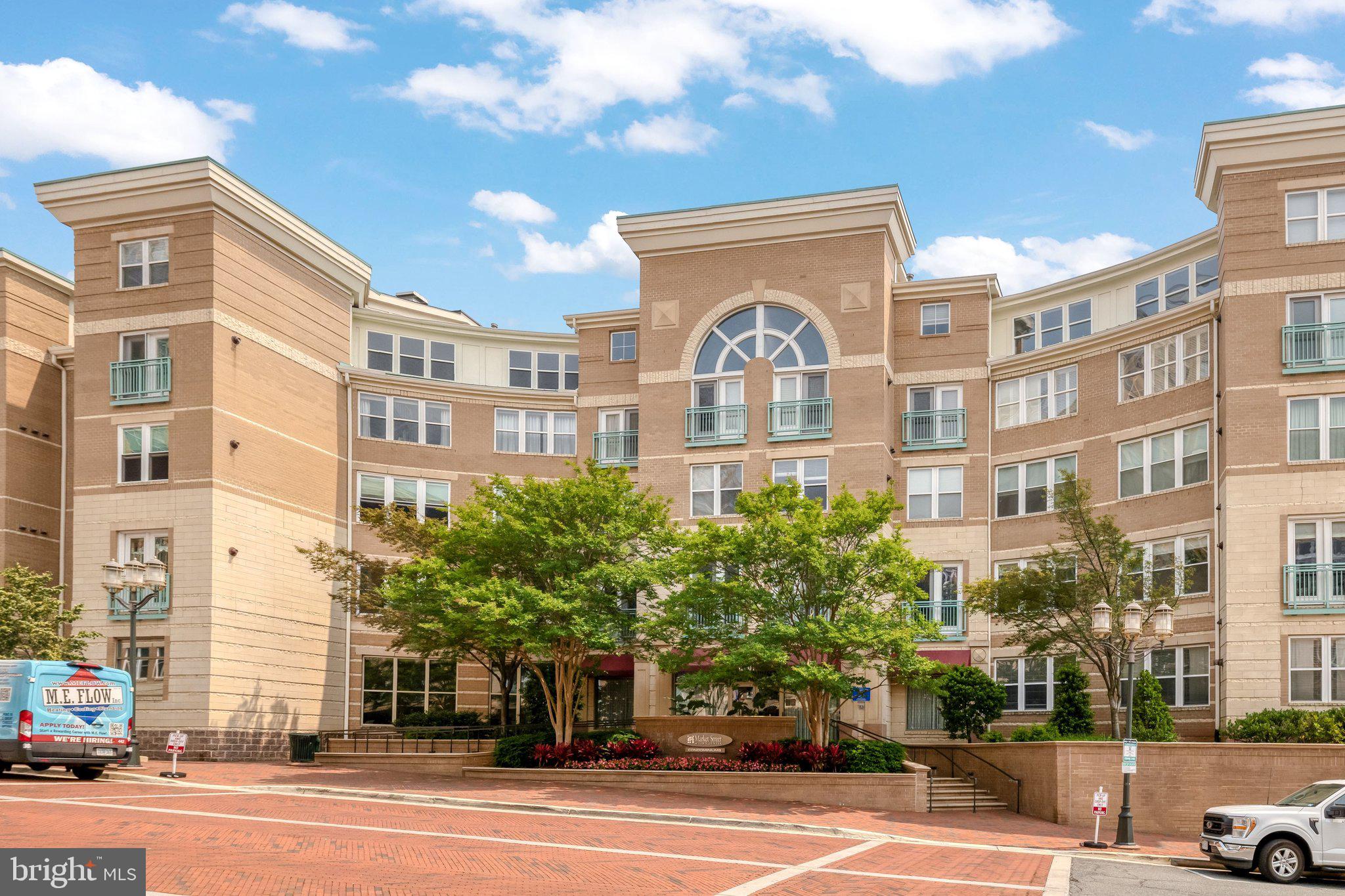 12001 Market Street, Unit 151 Reston, VA 20190 - Photo 2 of 25 a front view of a building with a garden