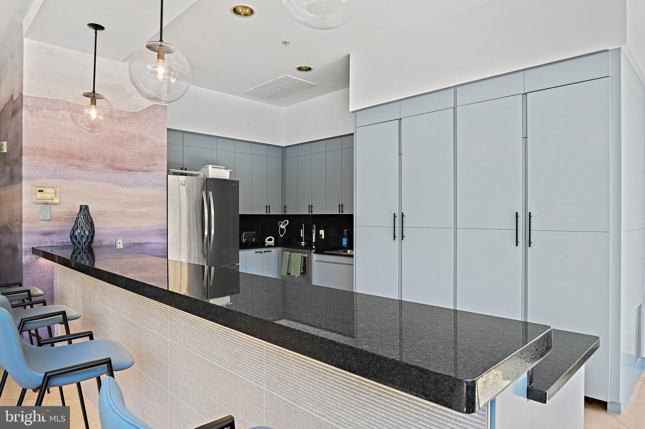12001 Market Street, Unit 151 Reston, VA 20190 - Photo 21 of 25 a kitchen with stainless steel appliances granite countertop a refrigerator a sink and white cabinets